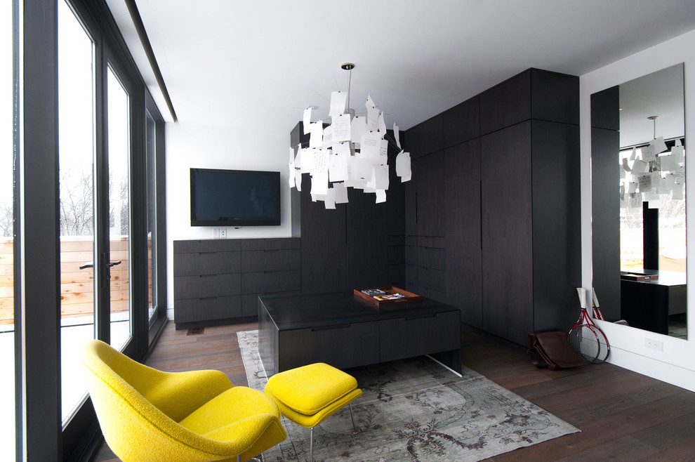 Dark, sophisticated colors with a splash of bright yellow work extremely well in this contemporary closet. A TV is a nice bonus too.